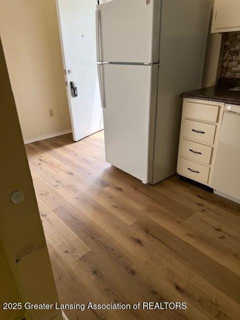 956 Trafalger Ln, East Lansing, MI 48823 - kitchen with freestanding refrigerator, light wood-type flooring, and white cabinetry