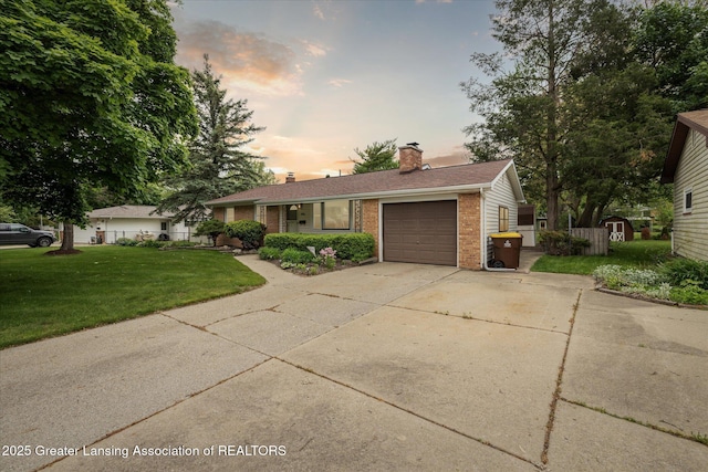 1416 Briarwood Dr, Lansing, MI 48917 - single story home featuring brick siding, a garage, driveway, and a chimney