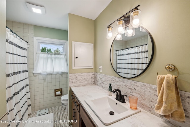 1416 Briarwood Dr, Lansing, MI 48917 - full bath with tile walls, vanity, toilet, tile patterned floors, and curtained shower