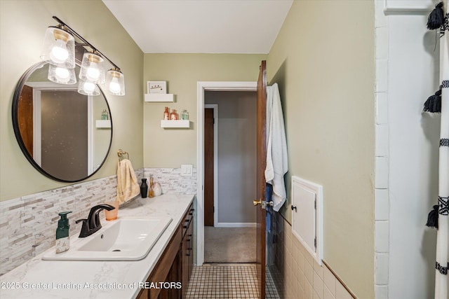 1416 Briarwood Dr, Lansing, MI 48917 - bathroom featuring vanity, tile patterned floors, and decorative backsplash