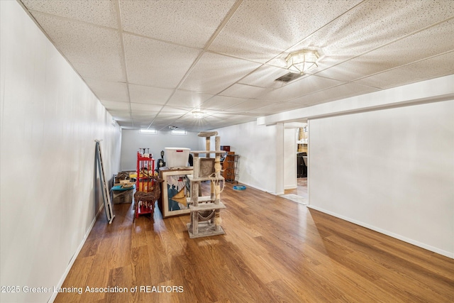 1416 Briarwood Dr, Lansing, MI 48917 - rec room featuring wood finished floors, a drop ceiling, and baseboards