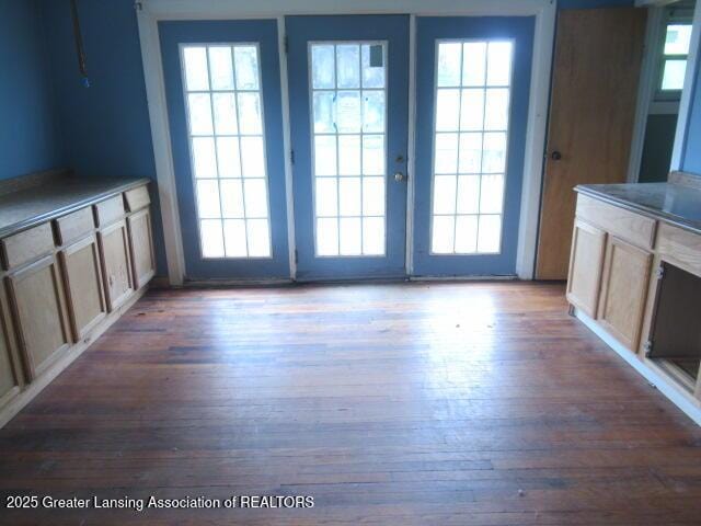 2071 Vandekarr Rd, Owosso, MI 48867 - unfurnished dining area with wood finished floors, healthy amount of natural light, and french doors