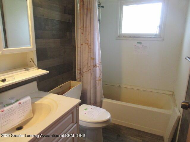2071 Vandekarr Rd, Owosso, MI 48867 - full bathroom featuring vanity, shower / bath combination with curtain, toilet, and wood finished floors
