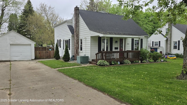 414 Vessey St, Portland, MI 48875 - cape cod-style house featuring covered porch, cooling unit, a detached garage, an outbuilding, and a chimney
