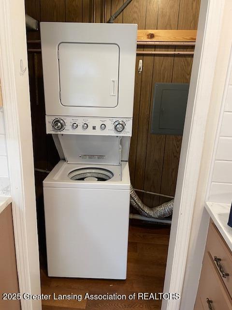 2303 Devonshire Ave, Lansing, MI 48910 - laundry room with estacked washer and dryer, electric panel, and wood finished floors