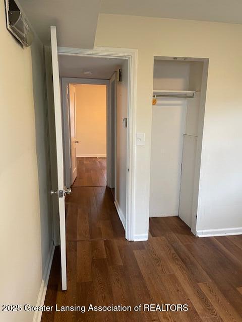 2303 Devonshire Ave, Lansing, MI 48910 - hall with dark wood-style floors and baseboards