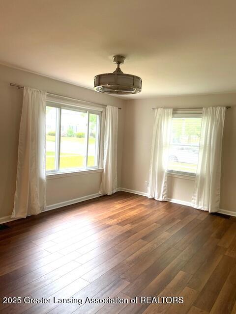 2303 Devonshire Ave, Lansing, MI 48910 - empty room featuring dark wood finished floors and baseboards