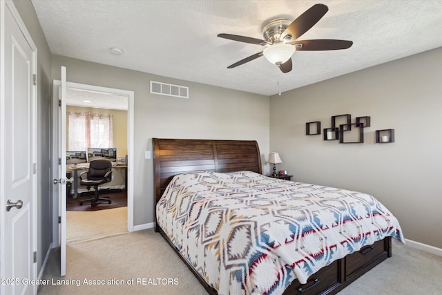 3893 E Plover Pl, East Lansing, MI 48823 - carpeted bedroom with an office area, baseboards, a textured ceiling, and ceiling fan