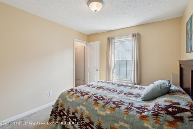 3893 E Plover Pl, East Lansing, MI 48823 - carpeted bedroom featuring baseboards and a textured ceiling