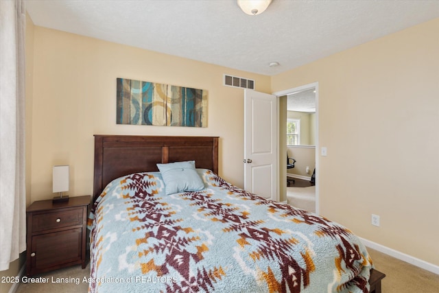 3893 E Plover Pl, East Lansing, MI 48823 - carpeted bedroom with baseboards and a textured ceiling