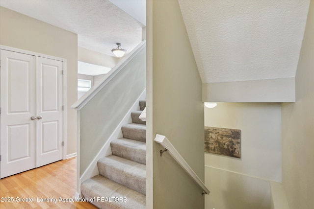 3893 E Plover Pl, East Lansing, MI 48823 - stairs featuring wood finished floors and a textured ceiling