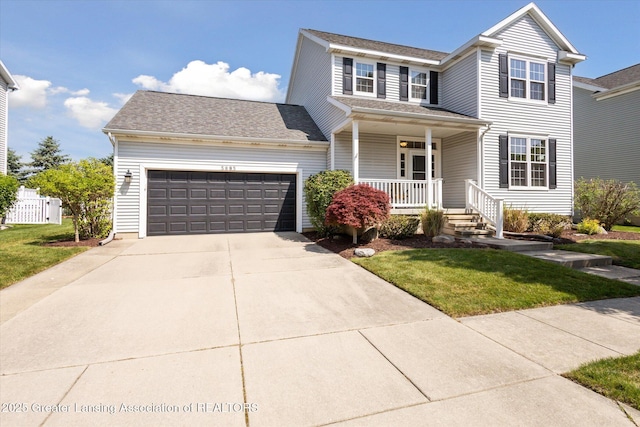 3893 E Plover Pl, East Lansing, MI 48823 - traditional-style home with covered porch, a garage, a front yard, and concrete driveway