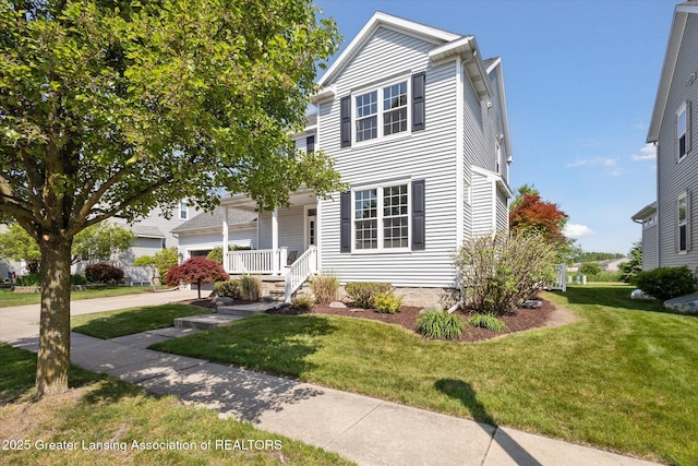3893 E Plover Pl, East Lansing, MI 48823 - view of front of house featuring covered porch, a front lawn, and driveway
