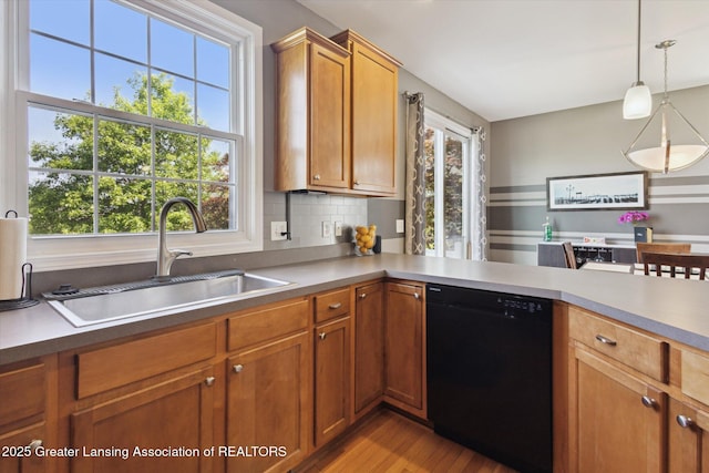 3893 E Plover Pl, East Lansing, MI 48823 - kitchen with dishwasher, a sink, plenty of natural light, and decorative light fixtures