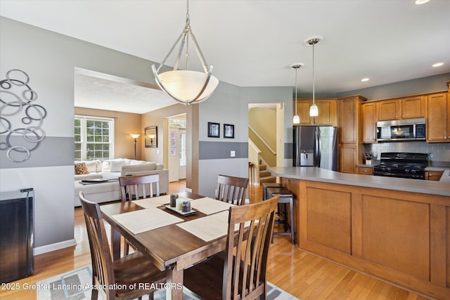 3893 E Plover Pl, East Lansing, MI 48823 - dining room featuring light wood-style floors, recessed lighting, and stairway