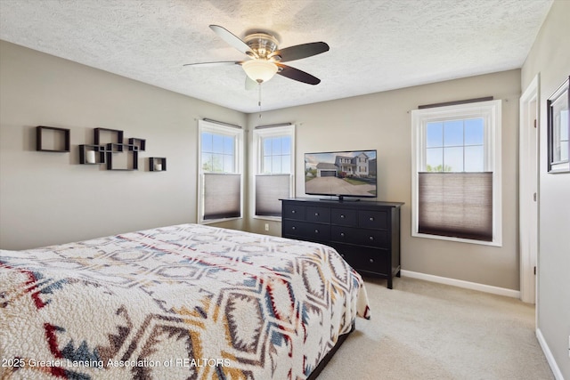 3893 E Plover Pl, East Lansing, MI 48823 - carpeted bedroom featuring baseboards, a textured ceiling, and ceiling fan