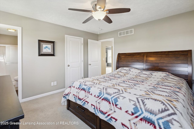 3893 E Plover Pl, East Lansing, MI 48823 - carpeted bedroom featuring baseboards, a ceiling fan, and connected bathroom