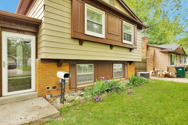 4716 Wainwright Ave, Lansing, MI 48911 - view of front facade featuring a front yard, brick siding, and central AC unit
