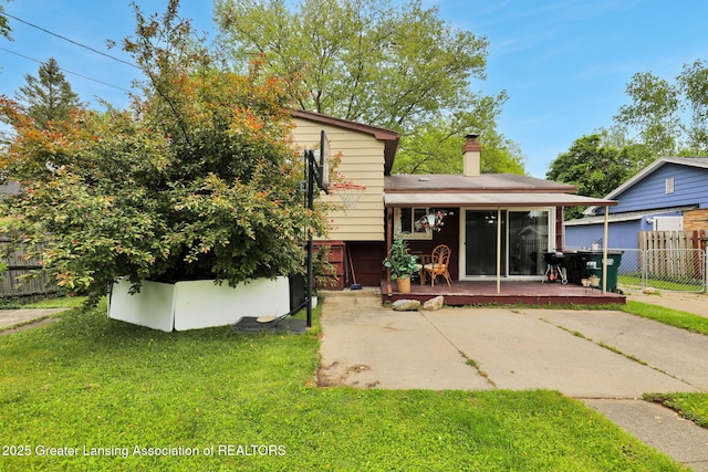 4716 Wainwright Ave, Lansing, MI 48911 - back of property featuring a deck and a patio area