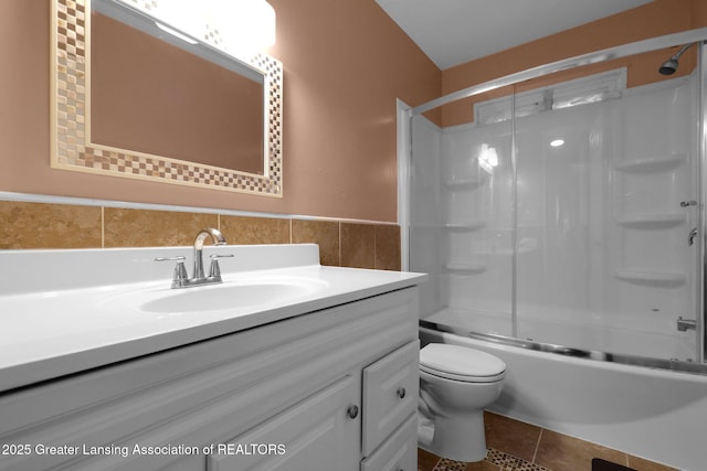 4716 Wainwright Ave, Lansing, MI 48911 - bathroom with vanity, toilet, enclosed tub / shower combo, tile patterned floors, and a wainscoted wall