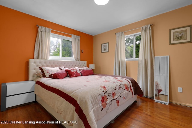 4716 Wainwright Ave, Lansing, MI 48911 - bedroom featuring multiple windows and wood finished floors