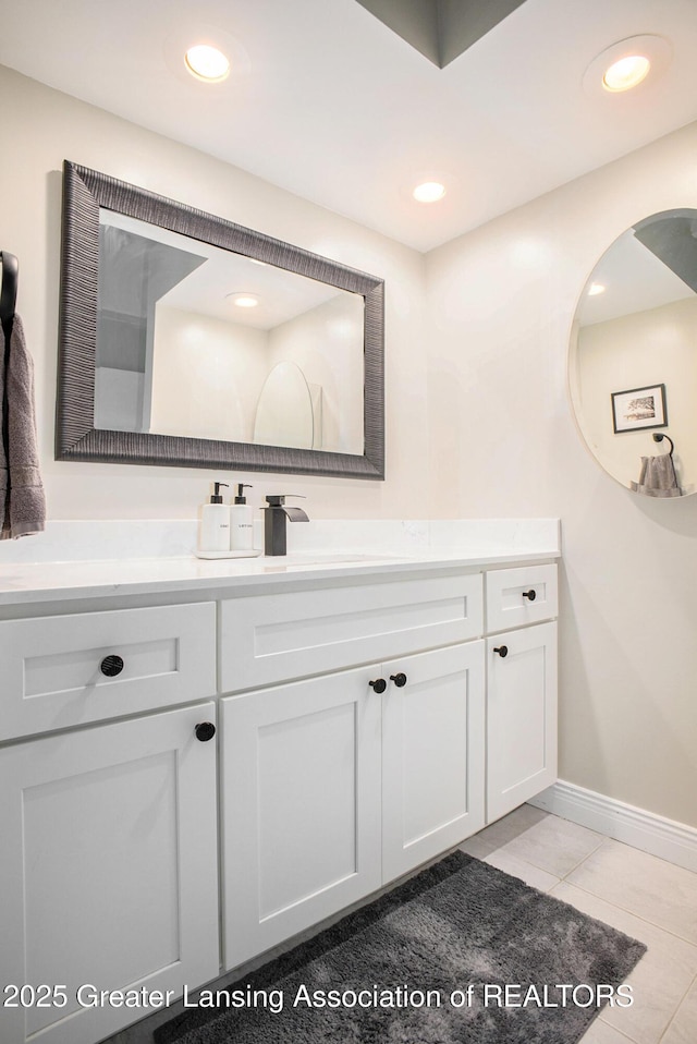 2022 Greenwich Ct, Lansing, MI 48910 - bathroom with tile patterned flooring, baseboards, and vanity