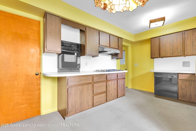 1450 N Hagadorn Rd, East Lansing, MI 48823 - kitchen with black appliances, under cabinet range hood, light colored carpet, light countertops, and baseboards