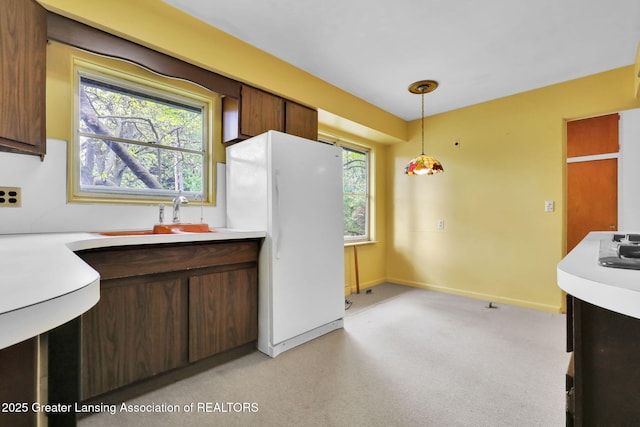 1450 N Hagadorn Rd, East Lansing, MI 48823 - kitchen with light countertops, freestanding refrigerator, and healthy amount of natural light
