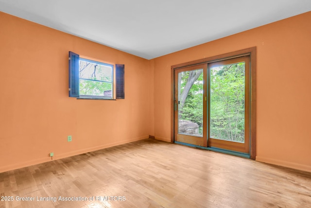 1450 N Hagadorn Rd, East Lansing, MI 48823 - spare room with wood finished floors and baseboards