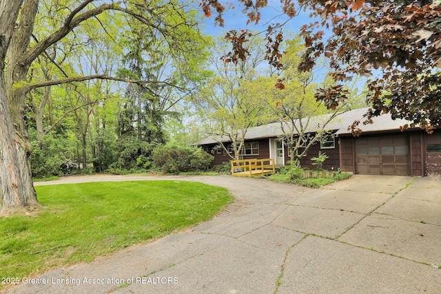 1450 N Hagadorn Rd, East Lansing, MI 48823 - view of front of home with driveway, an attached garage, and a front lawn