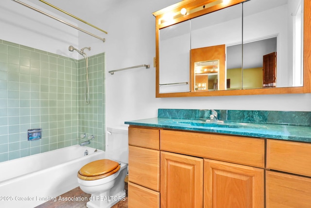1450 N Hagadorn Rd, East Lansing, MI 48823 - bathroom featuring toilet, vanity, and bathing tub / shower combination