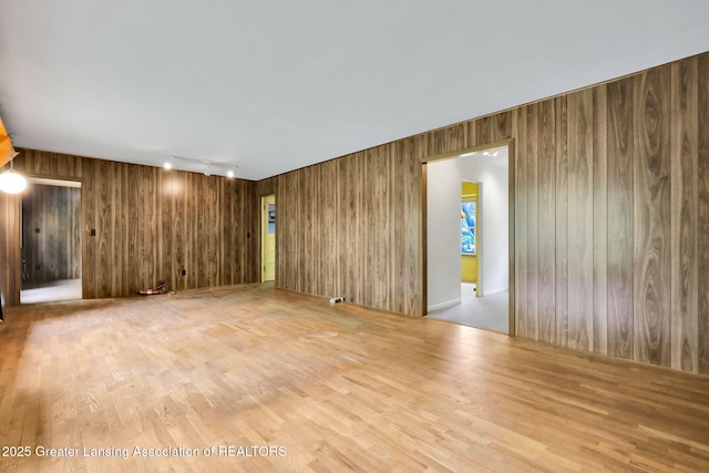 1450 N Hagadorn Rd, East Lansing, MI 48823 - spare room with wood finished floors and wood walls