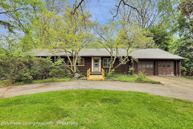 1450 N Hagadorn Rd, East Lansing, MI 48823 - view of front of property featuring a front yard, driveway, an attached garage, and roof with shingles