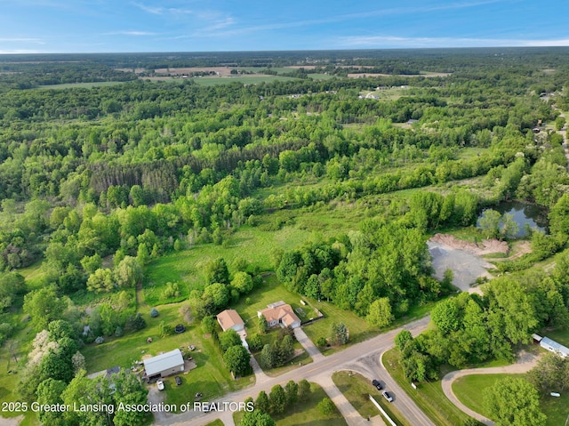 7413 E 5th Point Highway, Eaton Rapids, MI 48827 - aerial view of property and surrounding area featuring a heavily wooded area