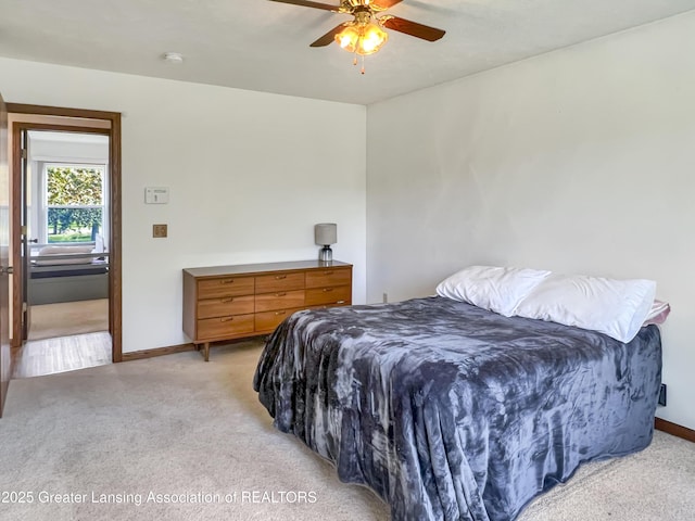 7413 E 5th Point Highway, Eaton Rapids, MI 48827 - bedroom featuring light carpet, baseboards, and ceiling fan
