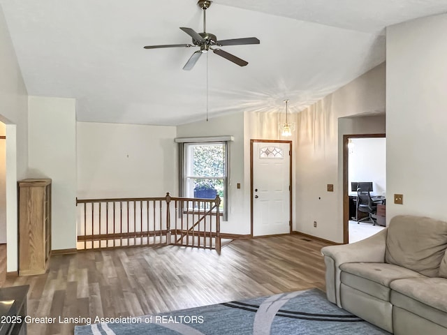 7413 E 5th Point Highway, Eaton Rapids, MI 48827 - living area featuring lofted ceiling, ceiling fan, wood finished floors, an office area, and baseboards