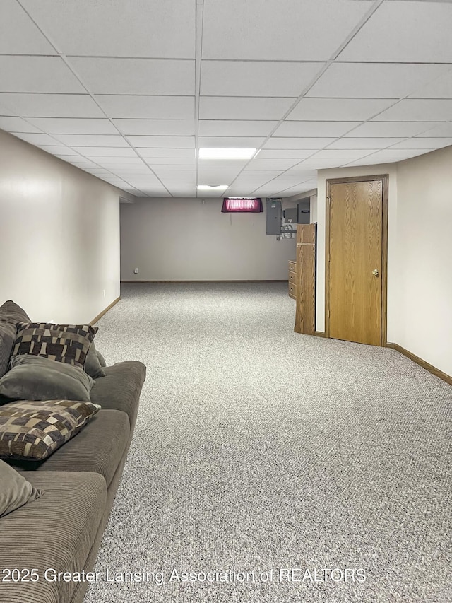 7413 E 5th Point Highway, Eaton Rapids, MI 48827 - finished below grade area featuring carpet floors, baseboards, a paneled ceiling, and electric panel