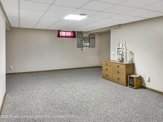 7413 E 5th Point Highway, Eaton Rapids, MI 48827 - below grade area featuring electric panel, baseboards, a drop ceiling, and carpet