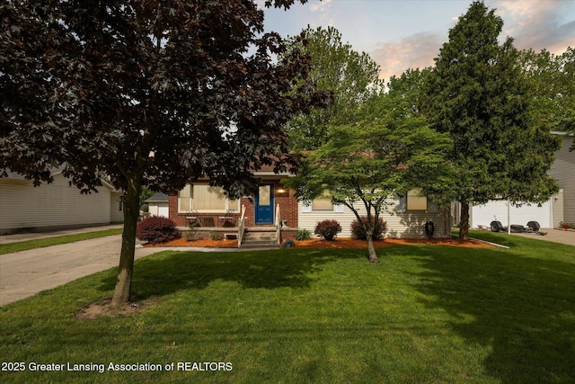 6187 Towar Ave, East Lansing, MI 48823 - view of property hidden behind natural elements with a front yard and brick siding