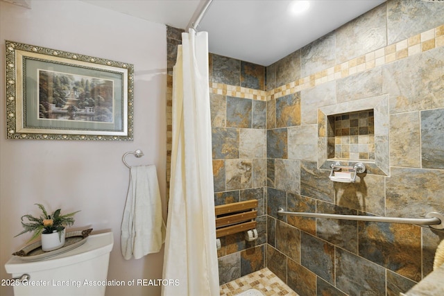 6187 Towar Ave, East Lansing, MI 48823 - bathroom featuring tiled shower and toilet