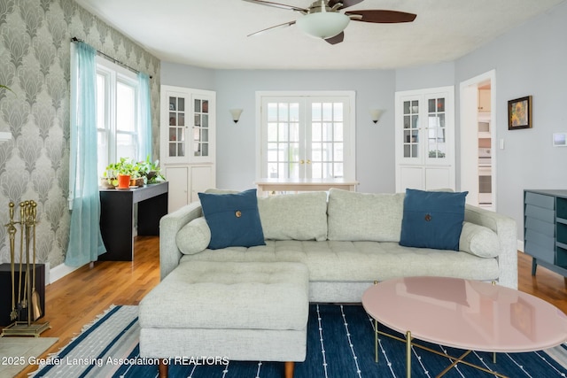 1311 Moores River Dr, Lansing, MI 48910 - living room featuring ceiling fan, wallpapered walls, and wood finished floors