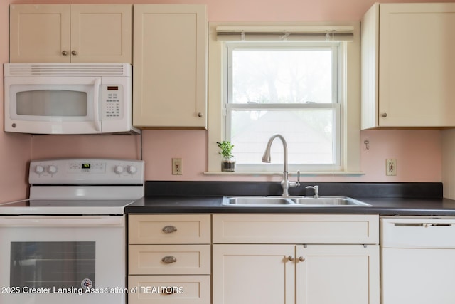 1311 Moores River Dr, Lansing, MI 48910 - kitchen with white appliances, a sink, dark countertops, and healthy amount of natural light