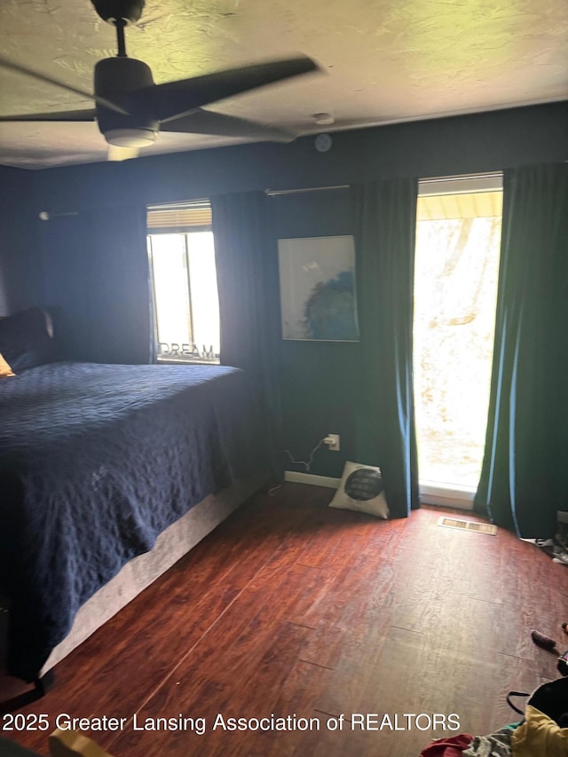 5880 Shaw St, Haslett, MI 48840 - bedroom with wood finished floors and a ceiling fan