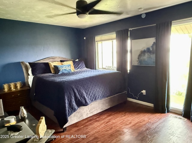 5880 Shaw St, Haslett, MI 48840 - bedroom with wood finished floors, a ceiling fan, and baseboards
