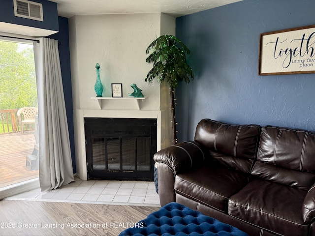 5880 Shaw St, Haslett, MI 48840 - living room with a glass covered fireplace and wood finished floors