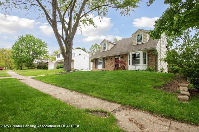 2024 Cogswell Dr, Lansing, MI 48906 - cape cod house featuring brick siding, a front yard, roof with shingles, and a garage
