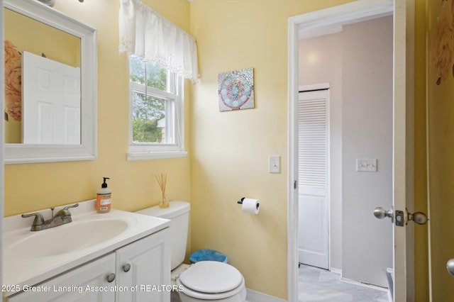2024 Cogswell Dr, Lansing, MI 48906 - bathroom featuring toilet, vanity, and baseboards