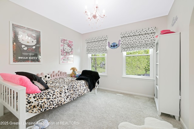 1232 Chemung Forest Dr, Howell, MI 48843 - carpeted bedroom with a chandelier and baseboards