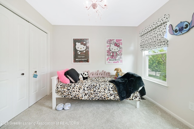 1232 Chemung Forest Dr, Howell, MI 48843 - carpeted bedroom with a closet, a chandelier, and baseboards