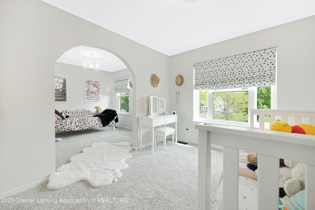 1232 Chemung Forest Dr, Howell, MI 48843 - bedroom with arched walkways, carpet floors, baseboards, and a chandelier